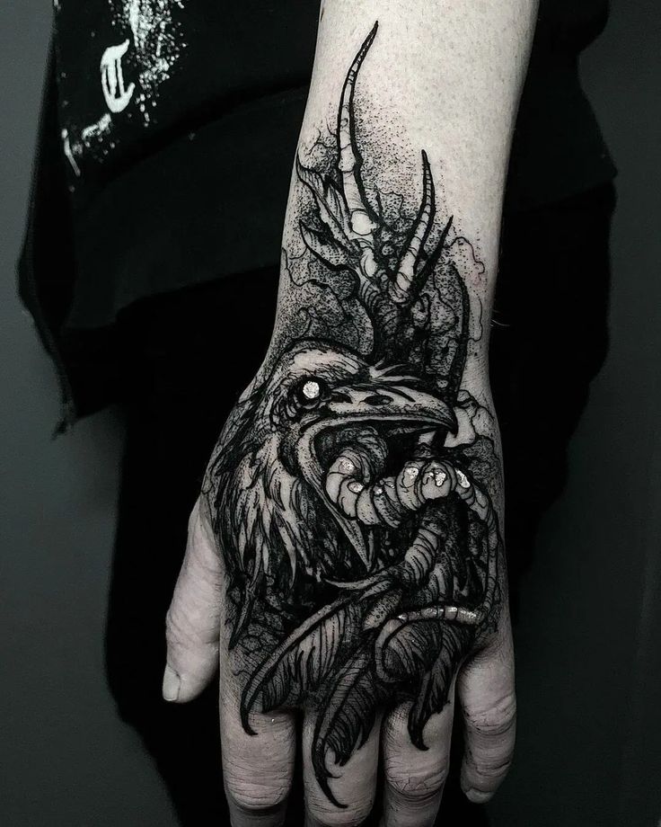 Blackwork raven and wing tattoo design for a dude or lady on hand tattoo ideas