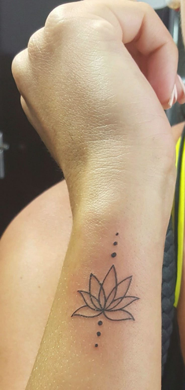 Minimalist lotus tattoo design for women on wrist tattoo ideas