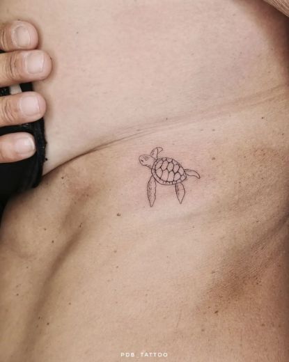Fine line turtle tattoo design for women on chest tattoo ideas