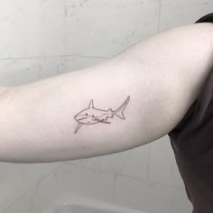 Minimalist shark tattoo idea for men on bicep tattoo ideas