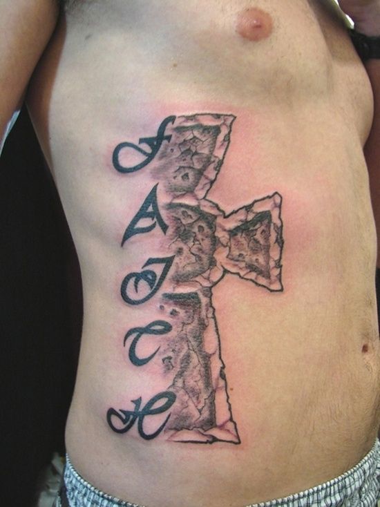 Faith cross tattoo design for men with textured stone effect on rib tattoo ideas