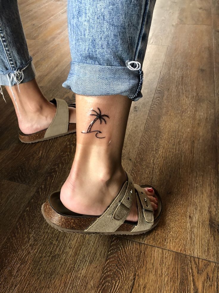 Minimalist palm tree and ocean tattoo design for women on ankle tattoo ideas