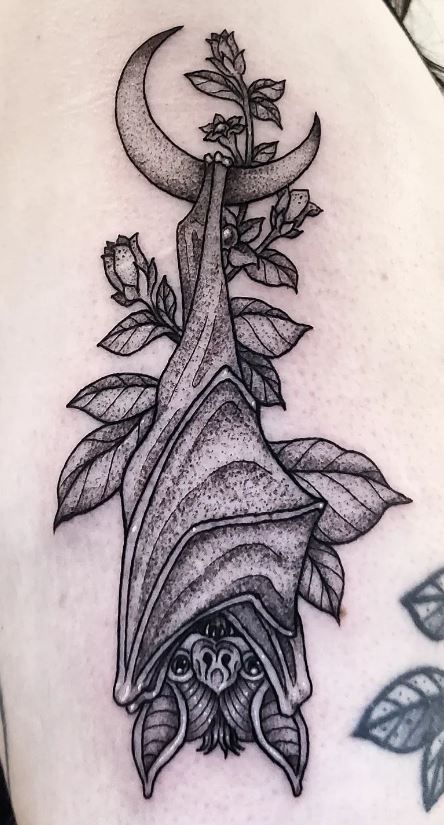 Black and grey bat, moon, and flower tattoo design for women on chest tattoo ideas