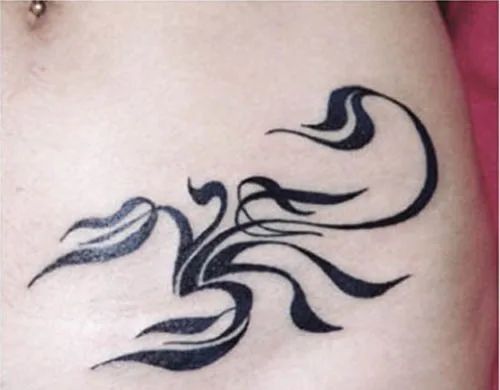 Tribal Scorpio with floral elements tattoo design for women on hip tattoo ideas
