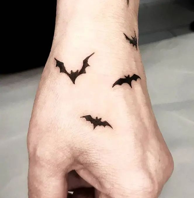 Minimalist bat tattoo design for men and women on hand tattoo ideas
