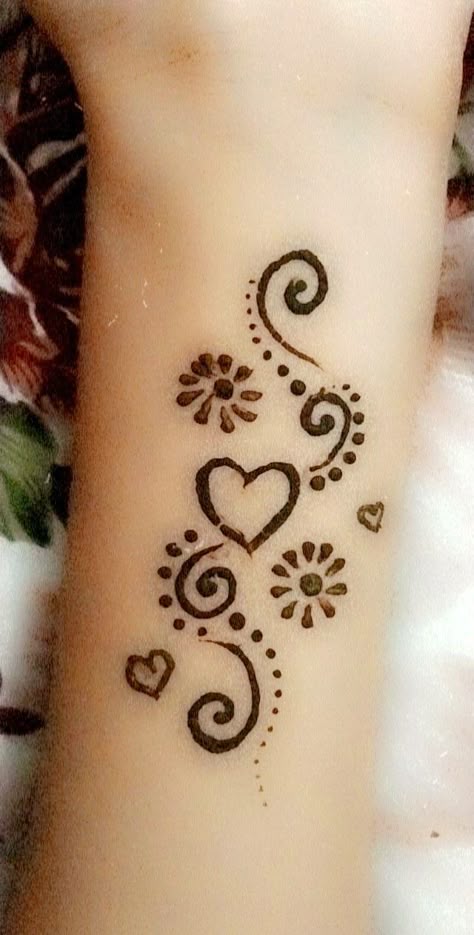 Floral linework tattoo design for women on wrist with hearts and flowers tattoo ideas
