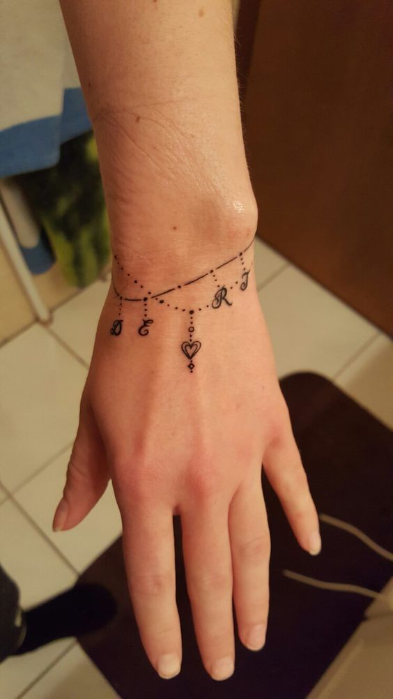 Fine line initial and heart tattoo design for women on wrist tattoo ideas