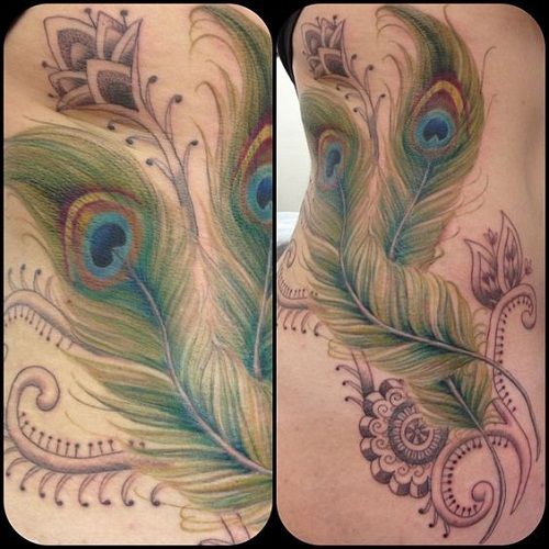 Realistic peacock feathers and floral tattoo design for women on rib tattoo ideas