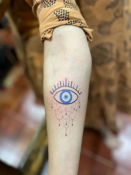 Fine Line evil eye tattoo design for women on forearm with dotwork details tattoo ideas