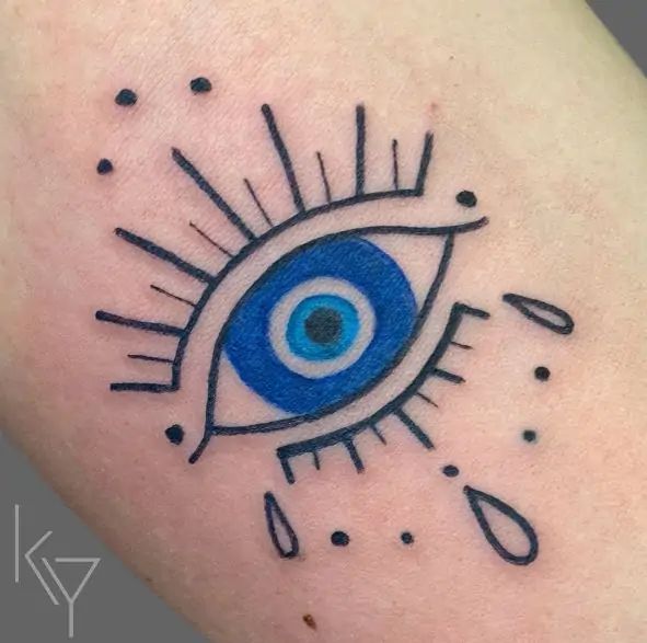 Minimalist evil eye tattoo design for women on the forearm tattoo ideas