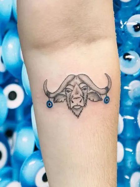 Black and grey bull and evil eye tattoo design for men and women on forearm tattoo ideas