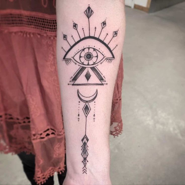 Geometric eye, moon, and arrow tattoo design for women on forearm tattoo ideas