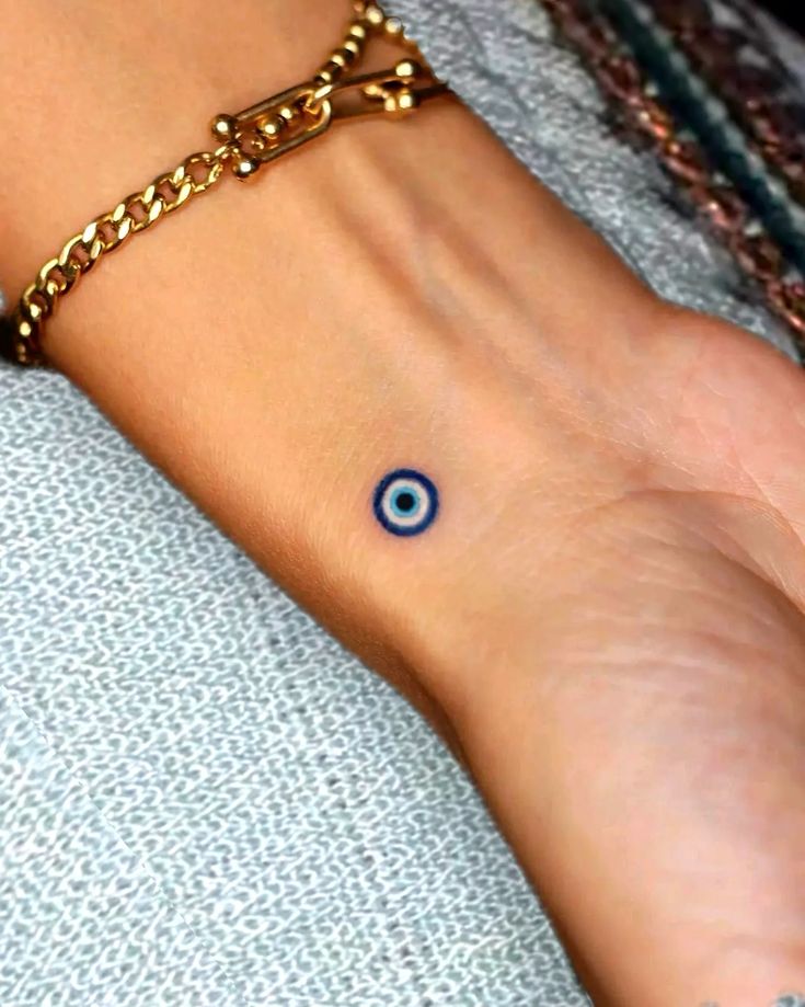 Fine line evil eye tattoo design for women on wrist tattoo ideas