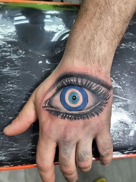 Realistic evil eye tattoo design for men on hand tattoo ideas