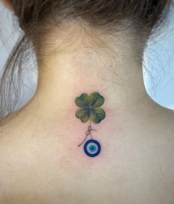 Realistic clover and evil eye tattoo design for women on neck tattoo ideas